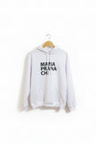 White hoodie with 'Mania Prana Ch' text on a hanger against a white wall.