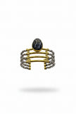 Hand holding a stack of three bracelets against a plain background